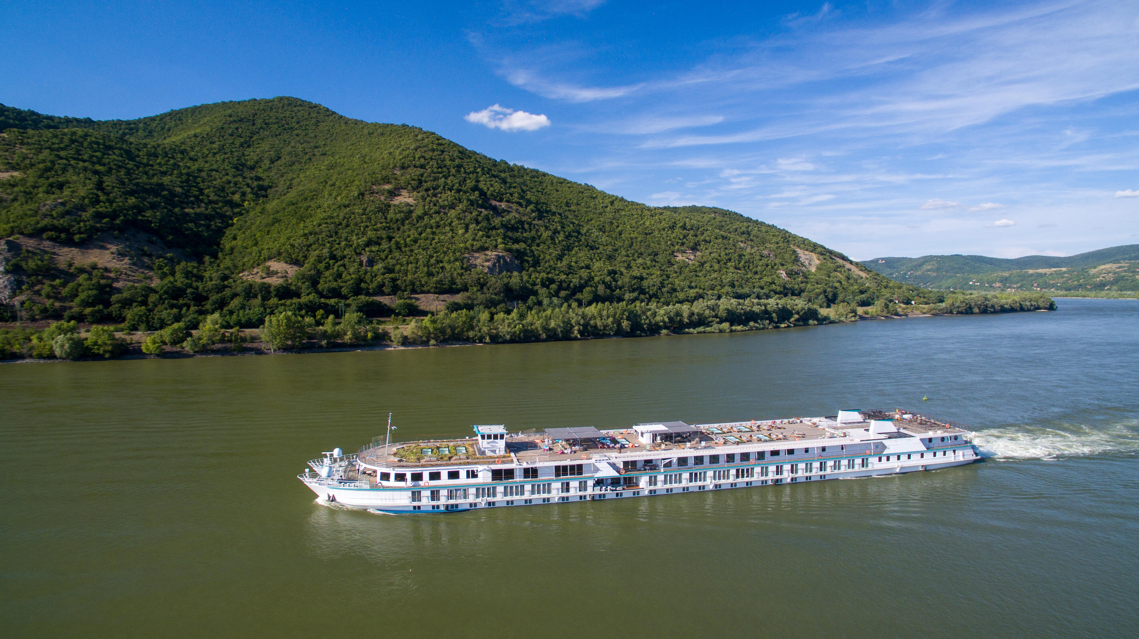 The Riverside Mozart on the Danube framed by green hills